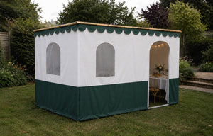 The Super Sukkah with scalloped trim in a garden